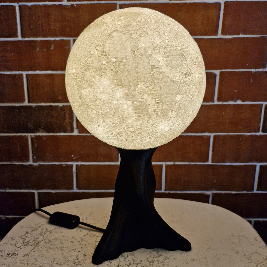 Print3D Africa Moon Table Lamp with illuminated lunar-texture shade and black base