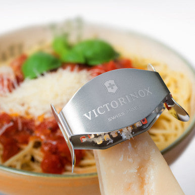 Victorinox 7.6076 cheese grater in use over pasta