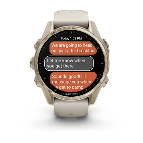 Garmin fēnix 8, front view with Soft Gold bezel and message display
