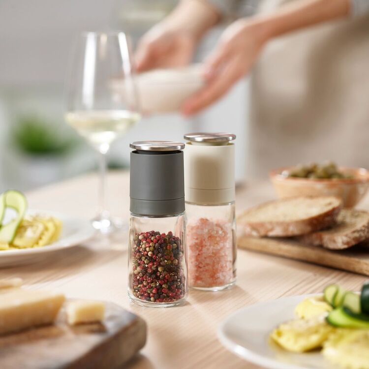 Joseph Joseph Duo No-spill salt and pepper mills standing on a dining table