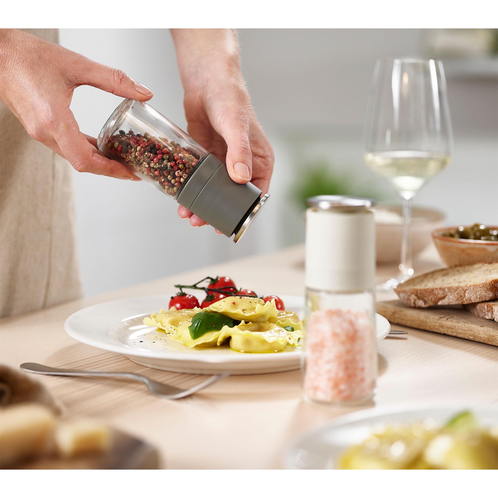 Joseph Joseph Duo No-spill pepper mill seasoning a plated meal