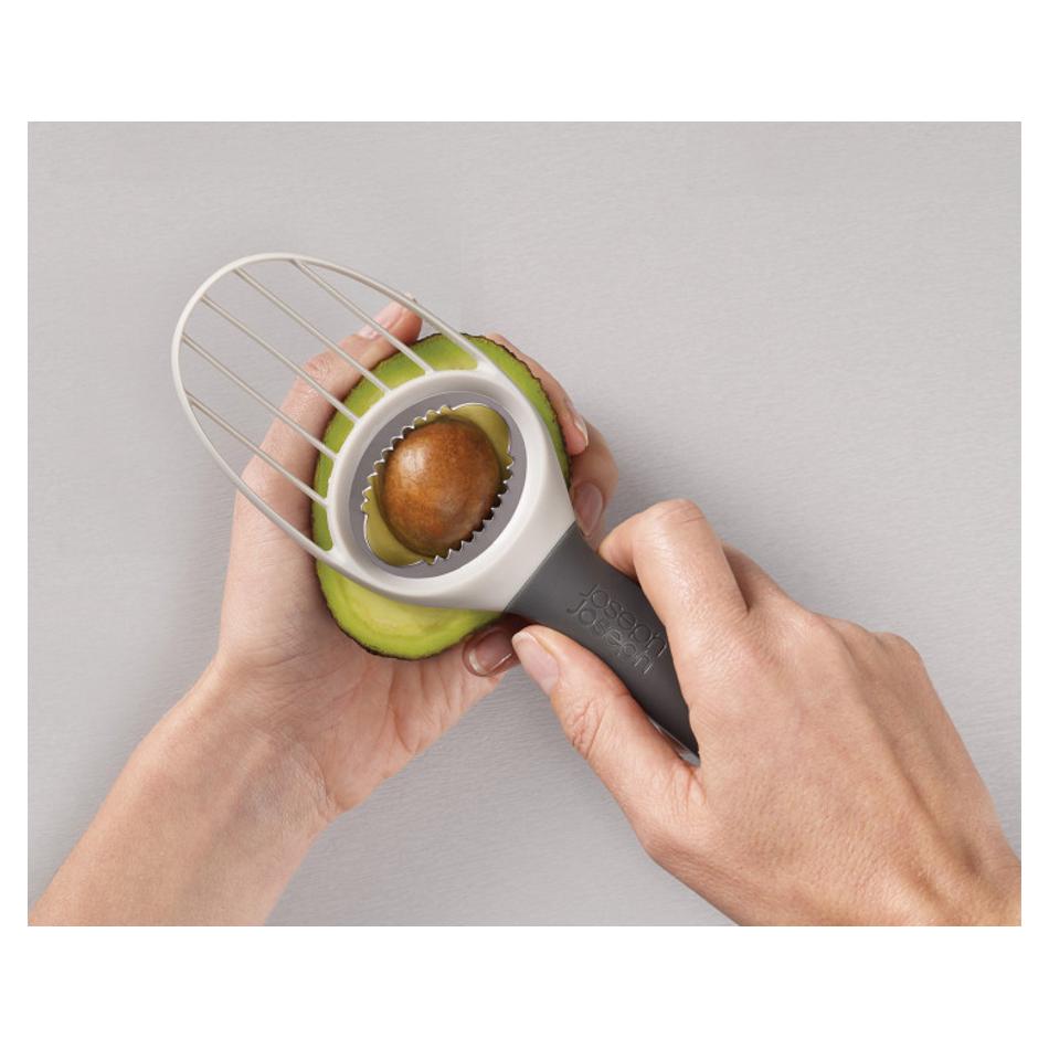 Joseph Joseph Duo Avocado Tool stone remover positioned over avocado pit