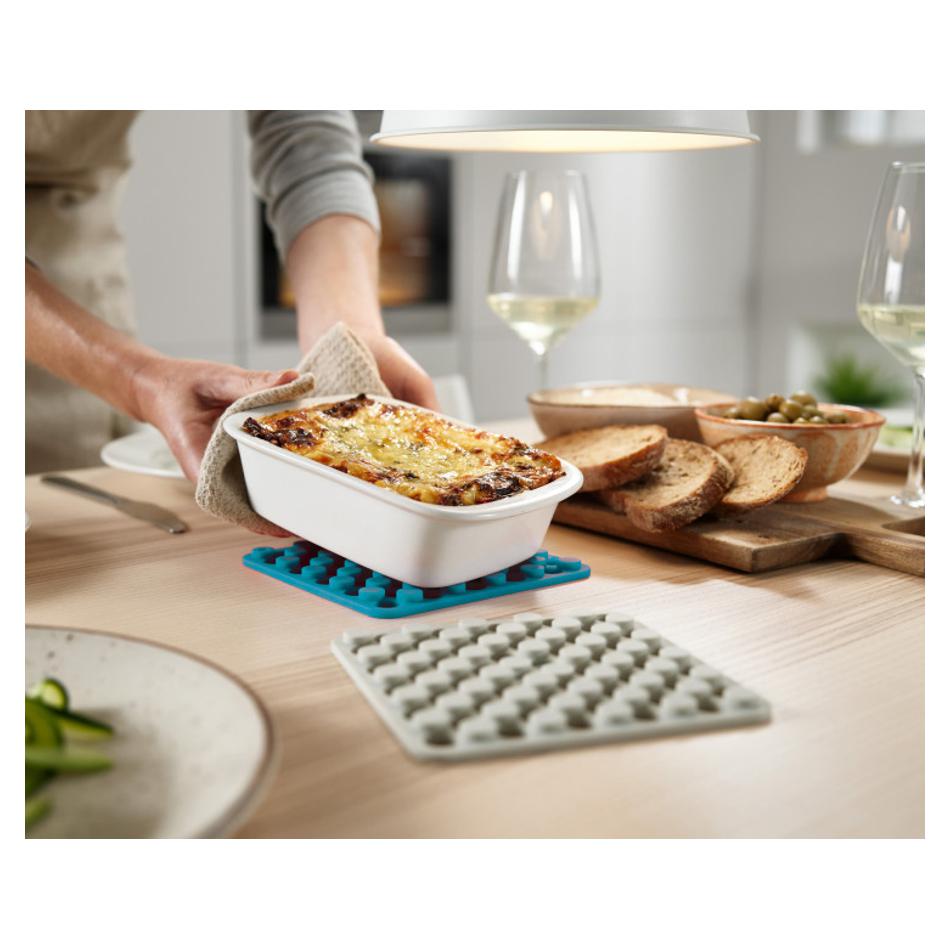 Joseph Joseph Duo Dark Opal silicone trivet protecting a table beneath a hot casserole