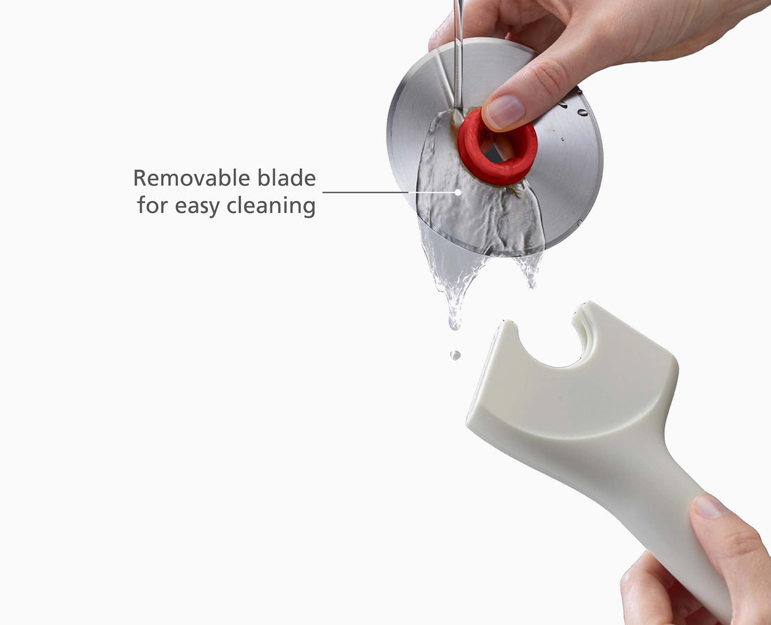 Joseph Joseph Ringo Easy-Clean Pizza Wheel Stone and Red 20232 — blade-release mechanism in use