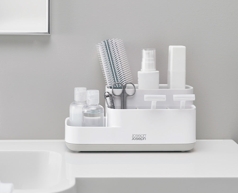 Joseph Joseph EasyStore Bathroom Caddy Grey and White 70513 — bathroom caddy organised beside a sink
