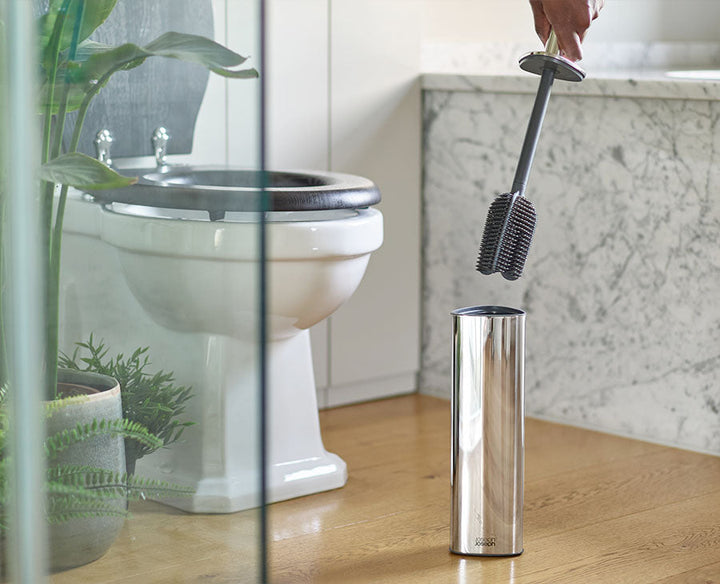 Joseph Joseph Flex 360 Luxe Advanced Toilet Brush Stainless Steel 70583 — toilet brush beside a modern toilet
