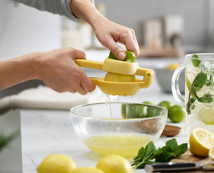 Joseph Joseph JuiceMax 20171 yellow citrus press squeezing a lemon
