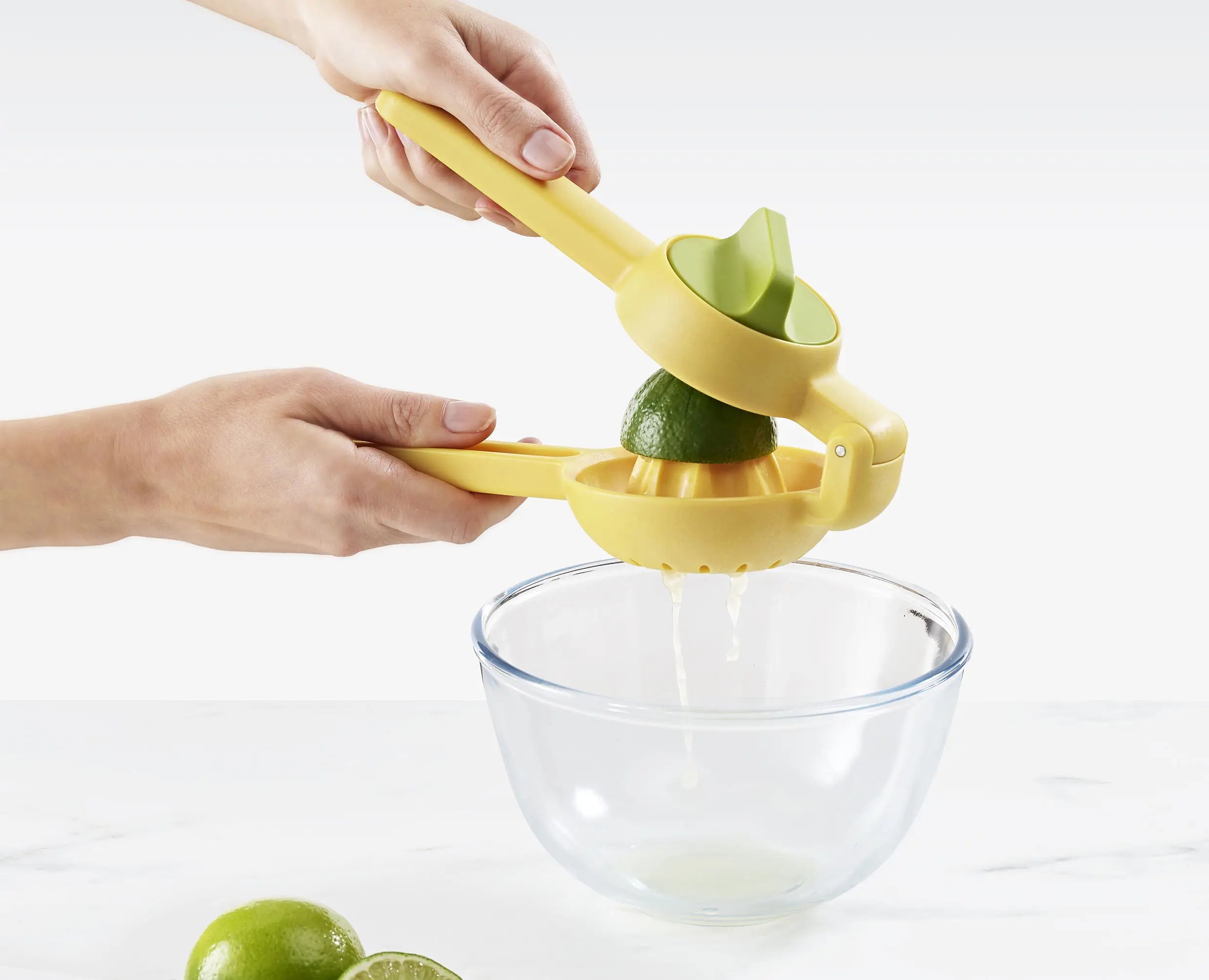 JuiceMax yellow citrus press showing integrated pip and pulp catcher