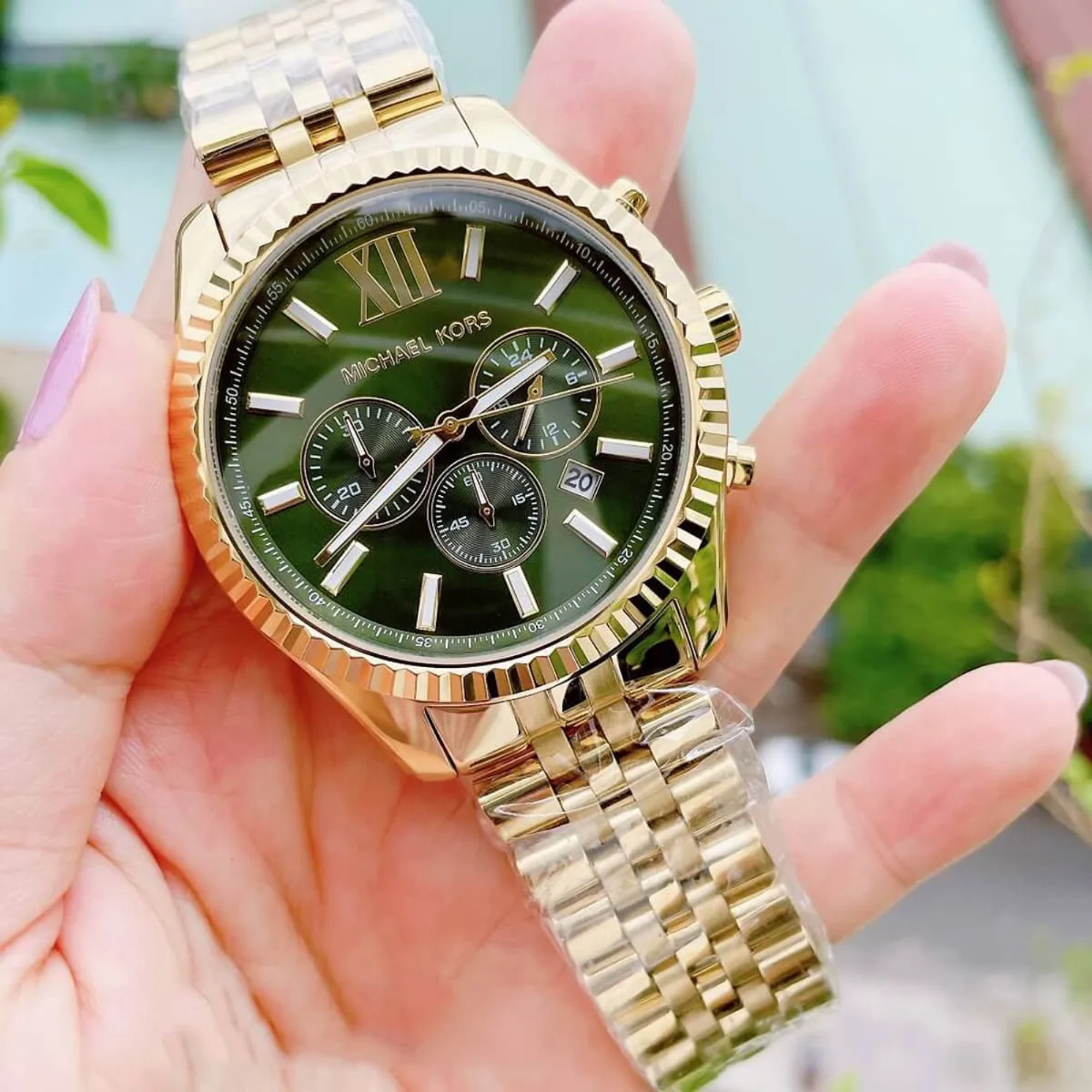 Michael Kors Lexington MK8446 gold-tone watch handheld angled front view