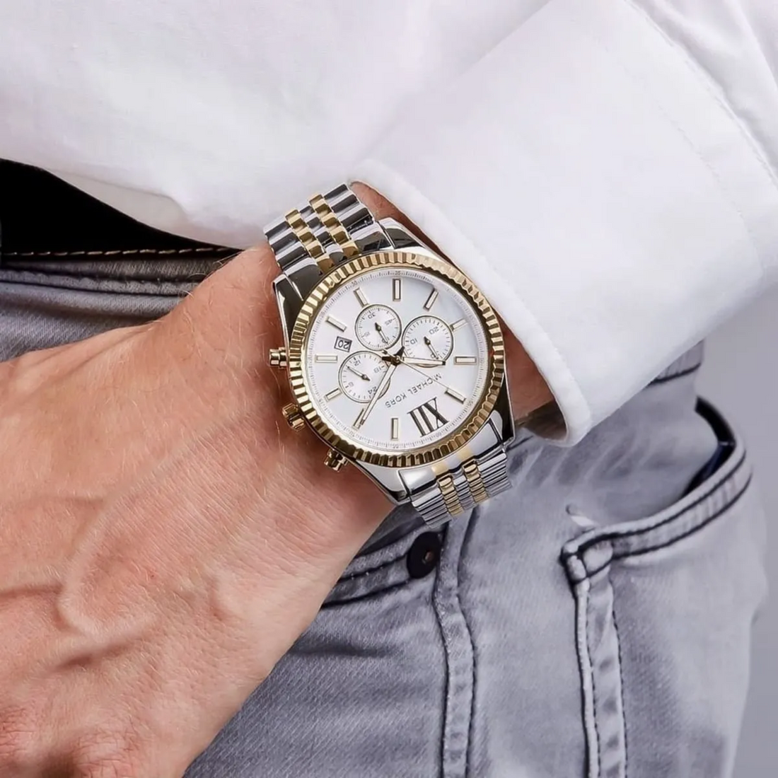Michael Kors MK8344 two-tone chronograph on wrist with white cuff