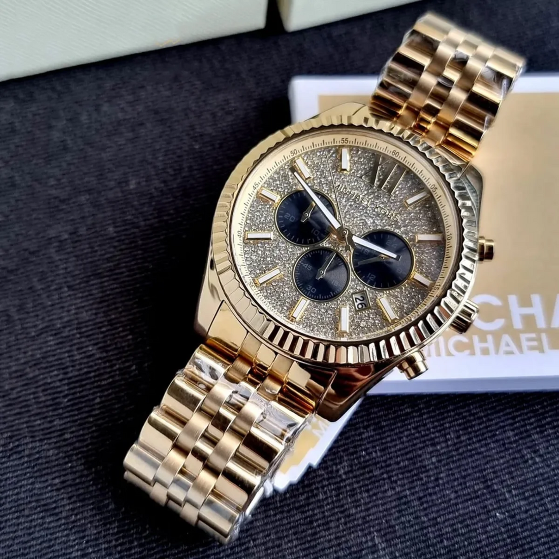 Michael Kors Lexington MK8494 gold-tone case side with MK crown and chronograph pushers
